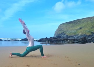 kneeling lunge yoga surfers beach cornwall cliffs sea