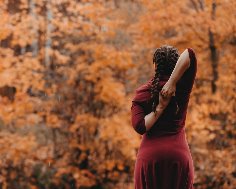 woman doing yoga in autumn woods